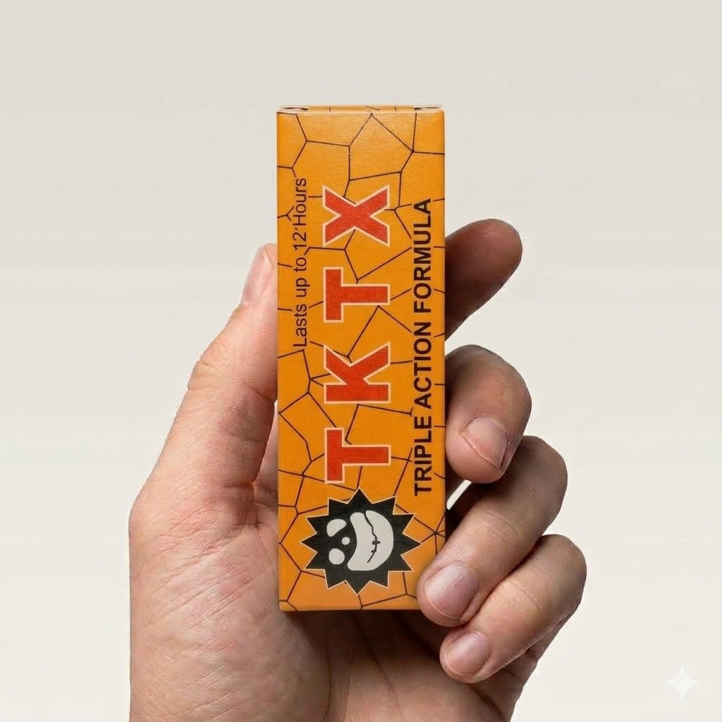 TKTX Gold Triple Action box held in hand